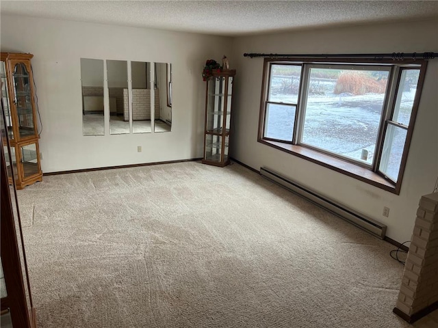 carpeted empty room with a textured ceiling and a baseboard radiator