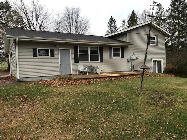 rear view of house featuring a yard