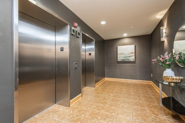 hallway with light tile patterned floors and elevator