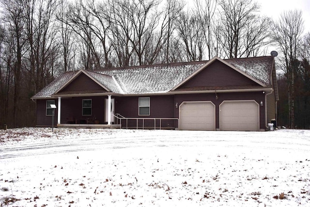 ranch-style house with a porch and a garage