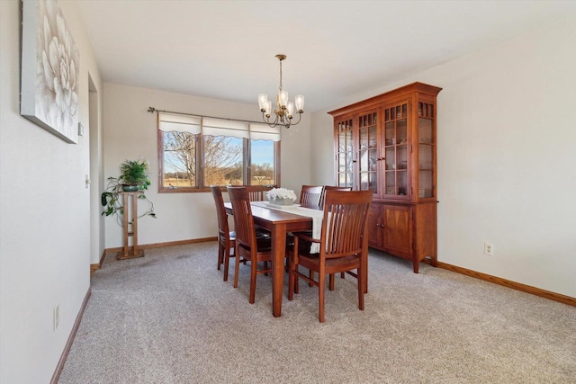 dining room with light carpet and an inviting chandelier