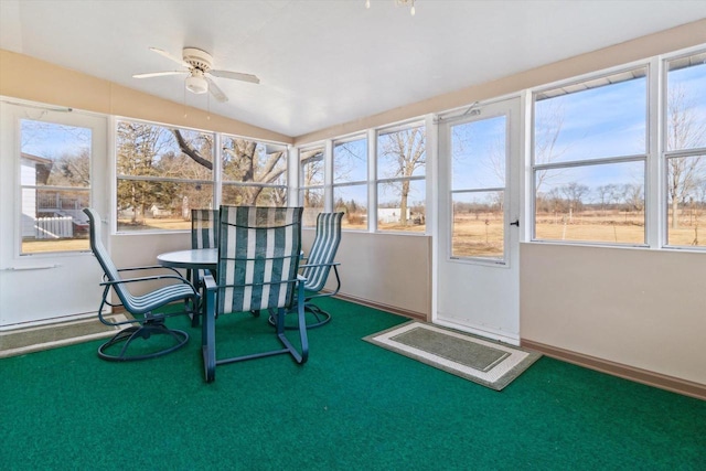 unfurnished sunroom featuring a wealth of natural light and ceiling fan