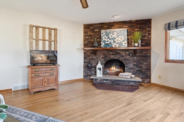 living room featuring hardwood / wood-style floors and a fireplace