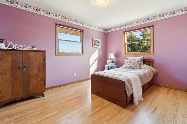 bedroom featuring light hardwood / wood-style floors and multiple windows