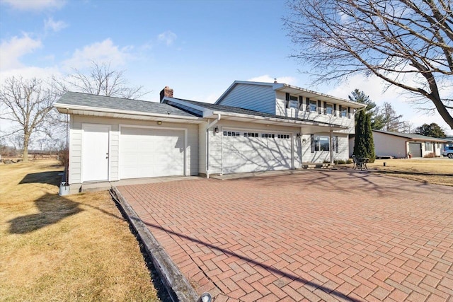 view of front of house featuring a garage and a balcony