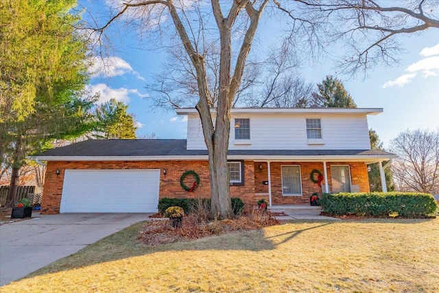 view of front property featuring a front yard, a porch, and a garage