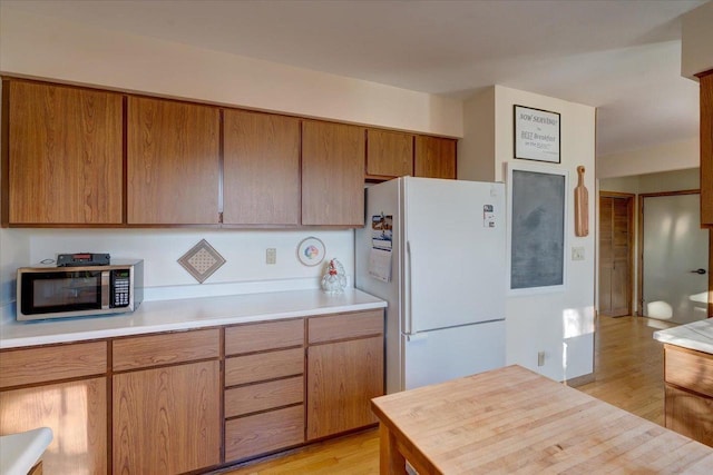 kitchen featuring white fridge and light hardwood / wood-style flooring