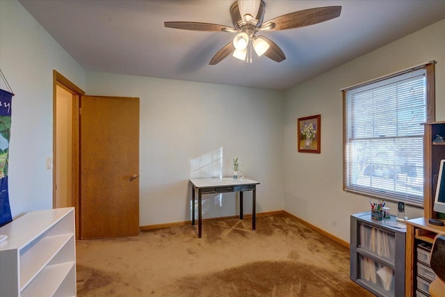 carpeted office featuring ceiling fan