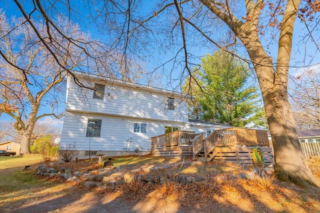 back of property with a wooden deck