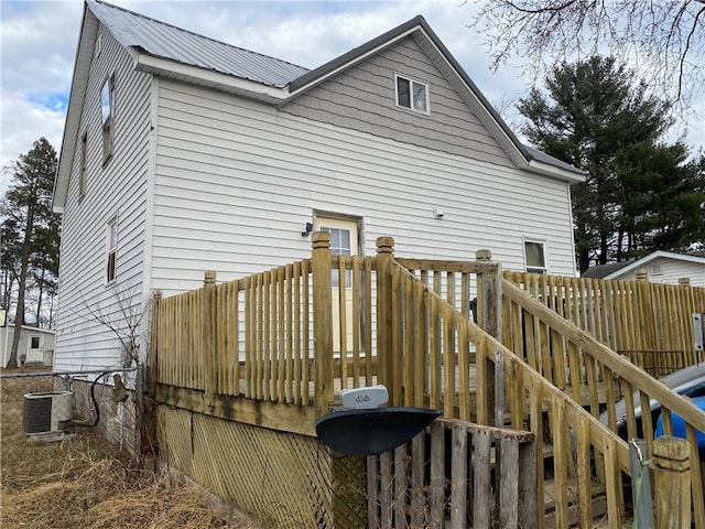 back of property featuring central AC unit and a wooden deck