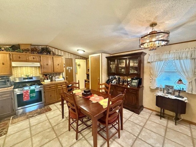 dining space featuring a textured ceiling and vaulted ceiling