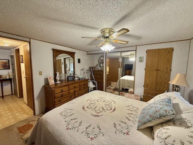 bedroom featuring a textured ceiling and ceiling fan