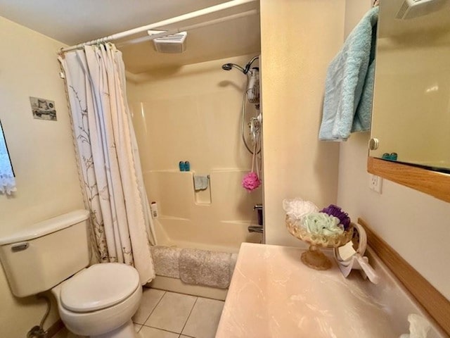 bathroom featuring tile patterned floors, shower / bath combination with curtain, and toilet