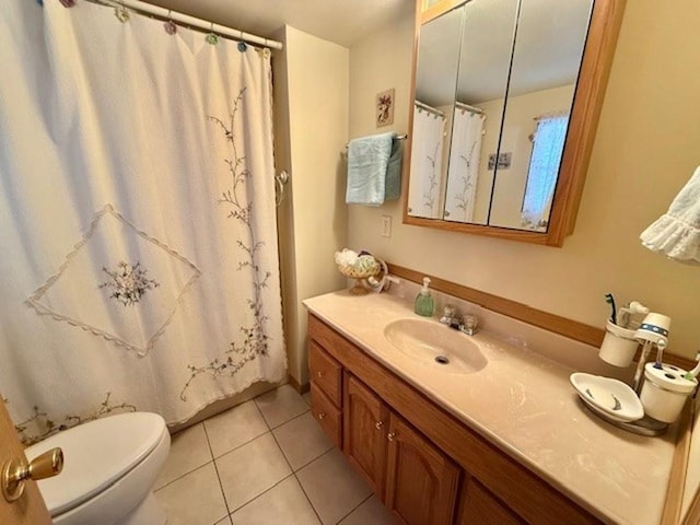 bathroom featuring tile patterned flooring, vanity, curtained shower, and toilet