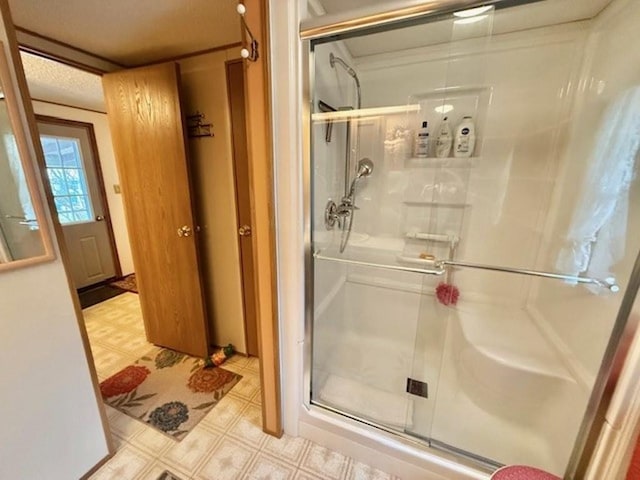 bathroom with a textured ceiling and walk in shower