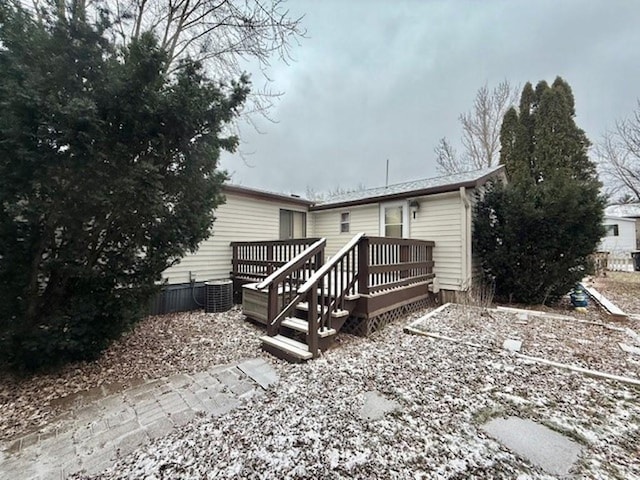 back of house featuring cooling unit and a wooden deck