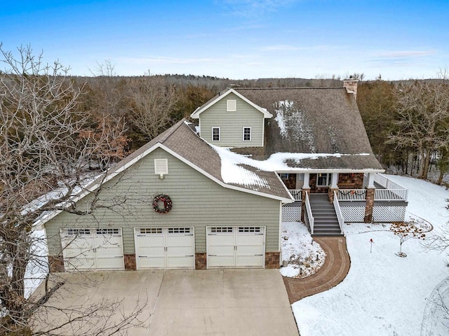 view of front of home featuring a porch and a garage