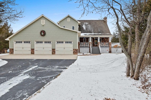 view of front of property featuring a porch and a garage