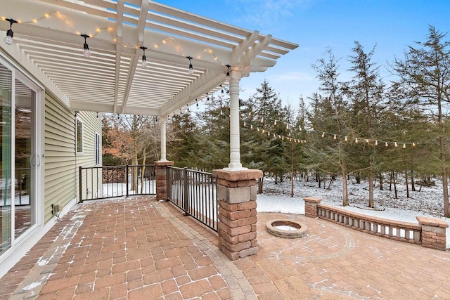 snow covered patio with a pergola