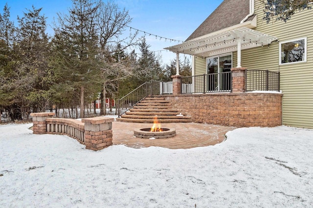 yard covered in snow featuring a pergola and an outdoor fire pit