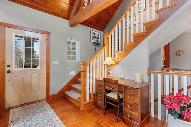 foyer entrance with vaulted ceiling with beams, wood ceiling, and hardwood / wood-style flooring