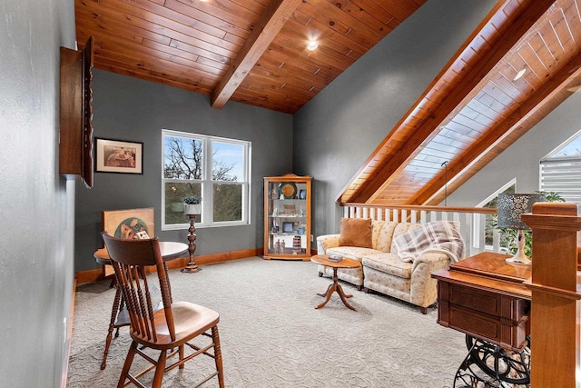 sitting room featuring lofted ceiling with beams, wooden ceiling, and light carpet