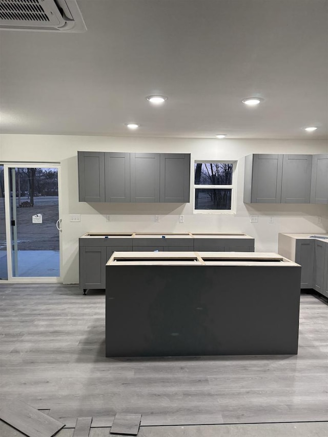 kitchen with light hardwood / wood-style floors and gray cabinetry