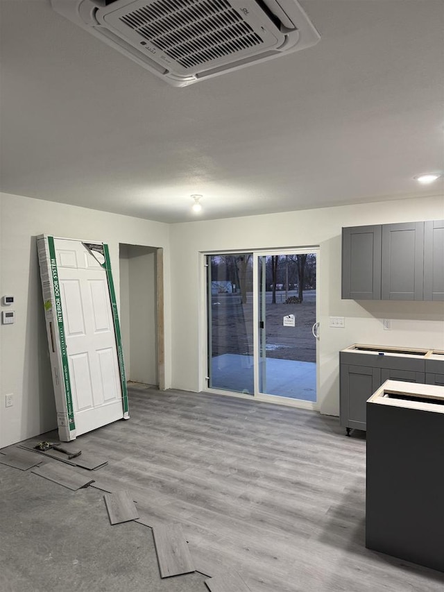 interior space featuring gray cabinetry and light hardwood / wood-style flooring