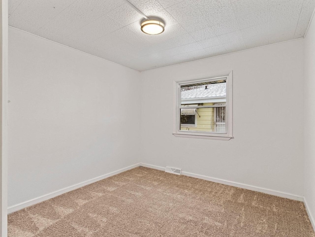 unfurnished room featuring carpet