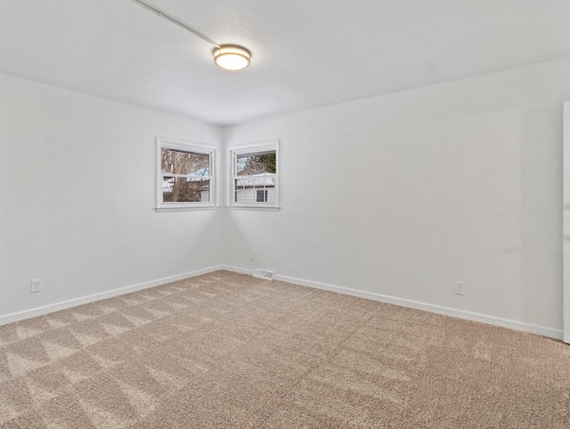 spare room featuring carpet floors