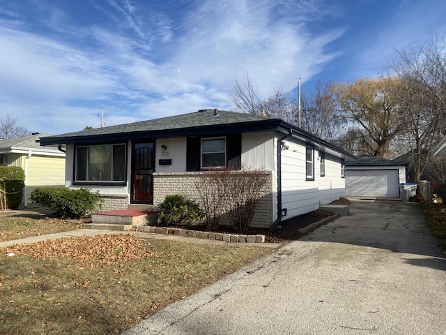 single story home with a garage and an outbuilding