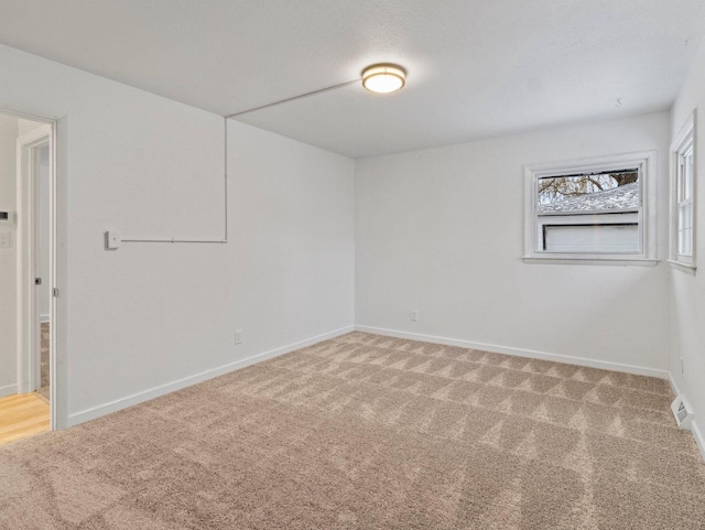 spare room featuring carpet floors