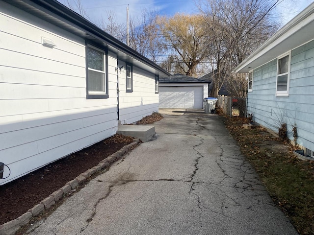 view of side of home with an outdoor structure and a garage