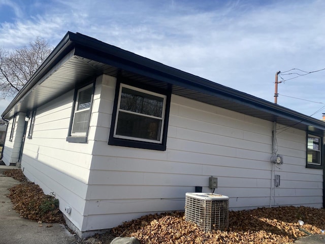 view of side of home featuring central AC unit