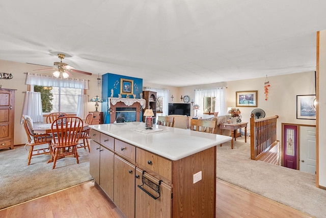 kitchen with a center island, light hardwood / wood-style floors, and ceiling fan