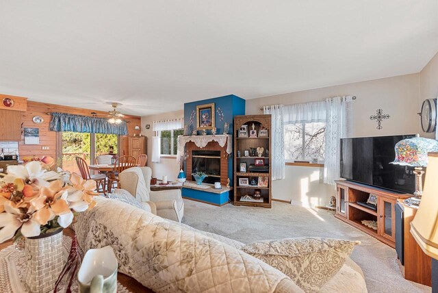 living room featuring ceiling fan and light colored carpet