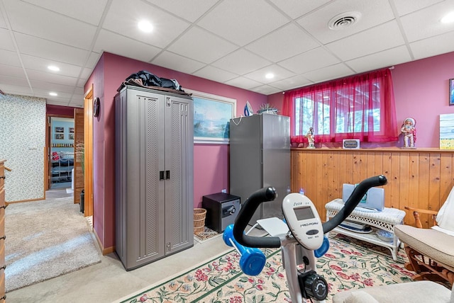 exercise room with a paneled ceiling