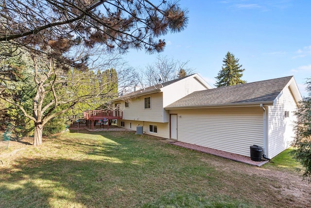 back of property featuring a deck and a yard