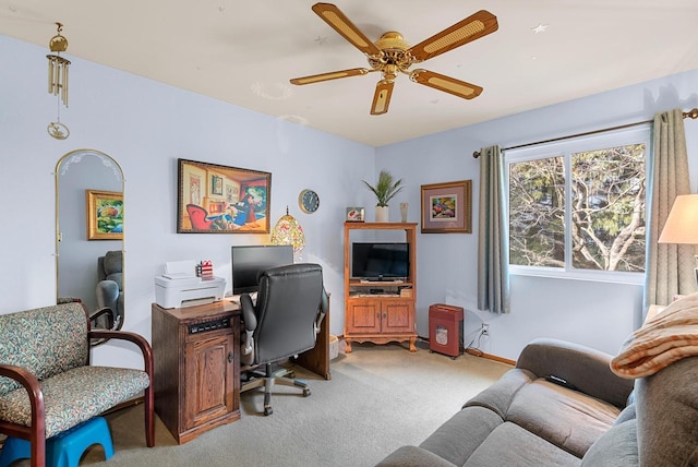 home office featuring light carpet and ceiling fan