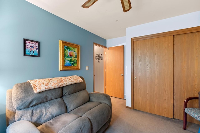 carpeted living room with ceiling fan