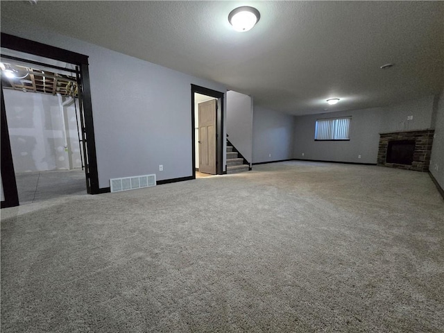 basement featuring a textured ceiling and carpet floors