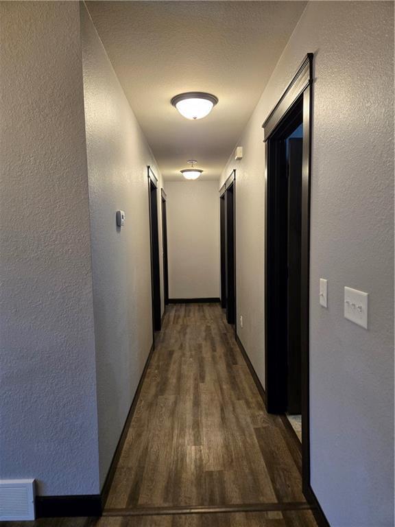 hallway with dark wood-type flooring