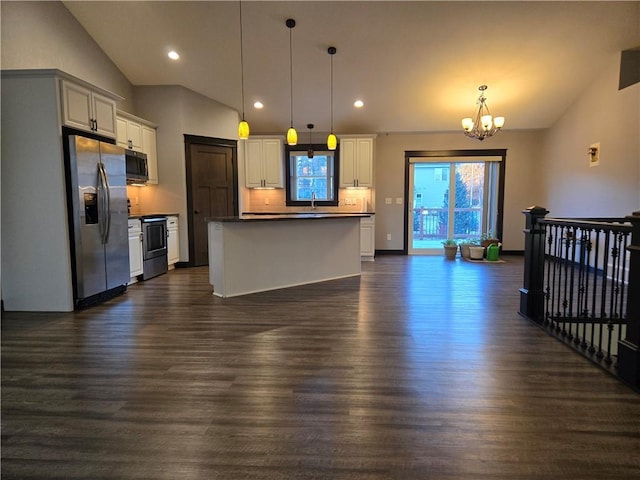 kitchen with dark hardwood / wood-style floors, hanging light fixtures, and appliances with stainless steel finishes