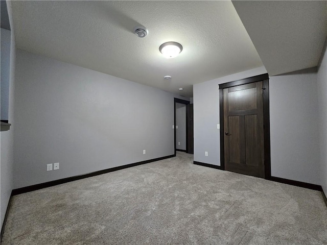 unfurnished bedroom with a textured ceiling and light carpet