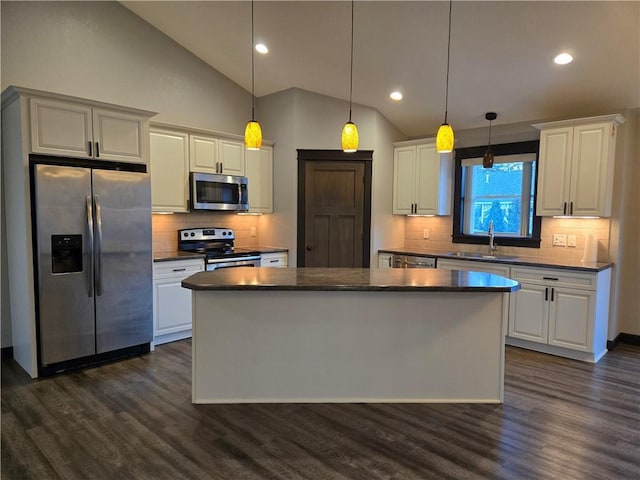 kitchen featuring dark wood-type flooring, white cabinets, sink, appliances with stainless steel finishes, and decorative light fixtures