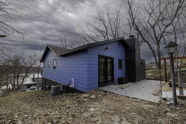 rear view of house featuring central AC