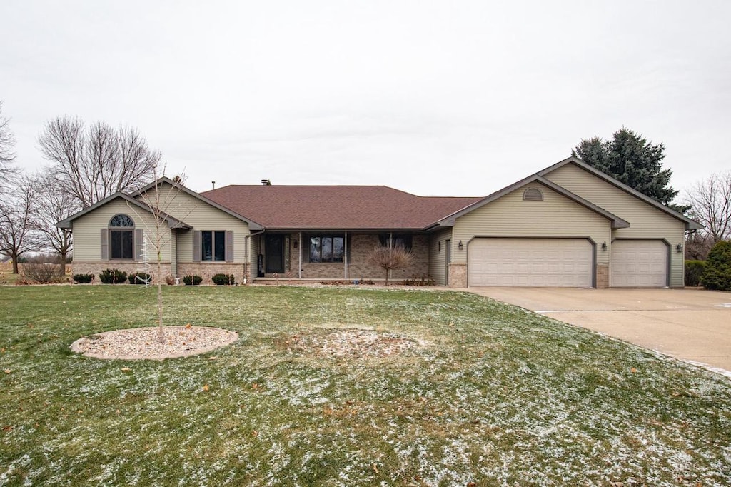 ranch-style house with a front yard and a garage