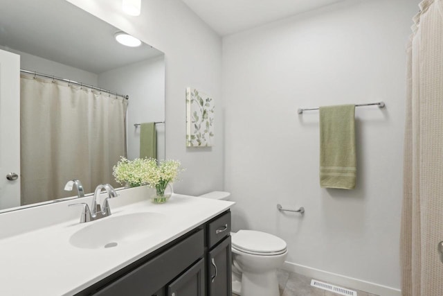 bathroom with tile patterned floors, vanity, and toilet