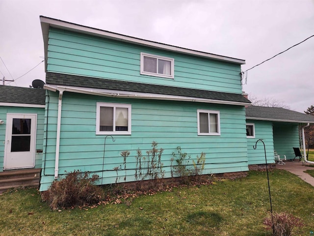 view of side of home with a lawn