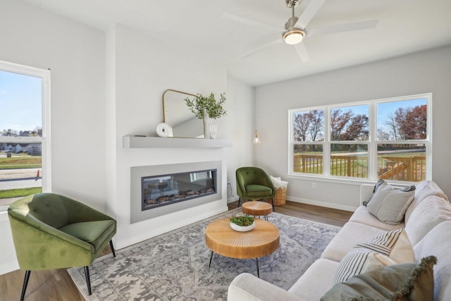 living room with ceiling fan, hardwood / wood-style floors, and a healthy amount of sunlight